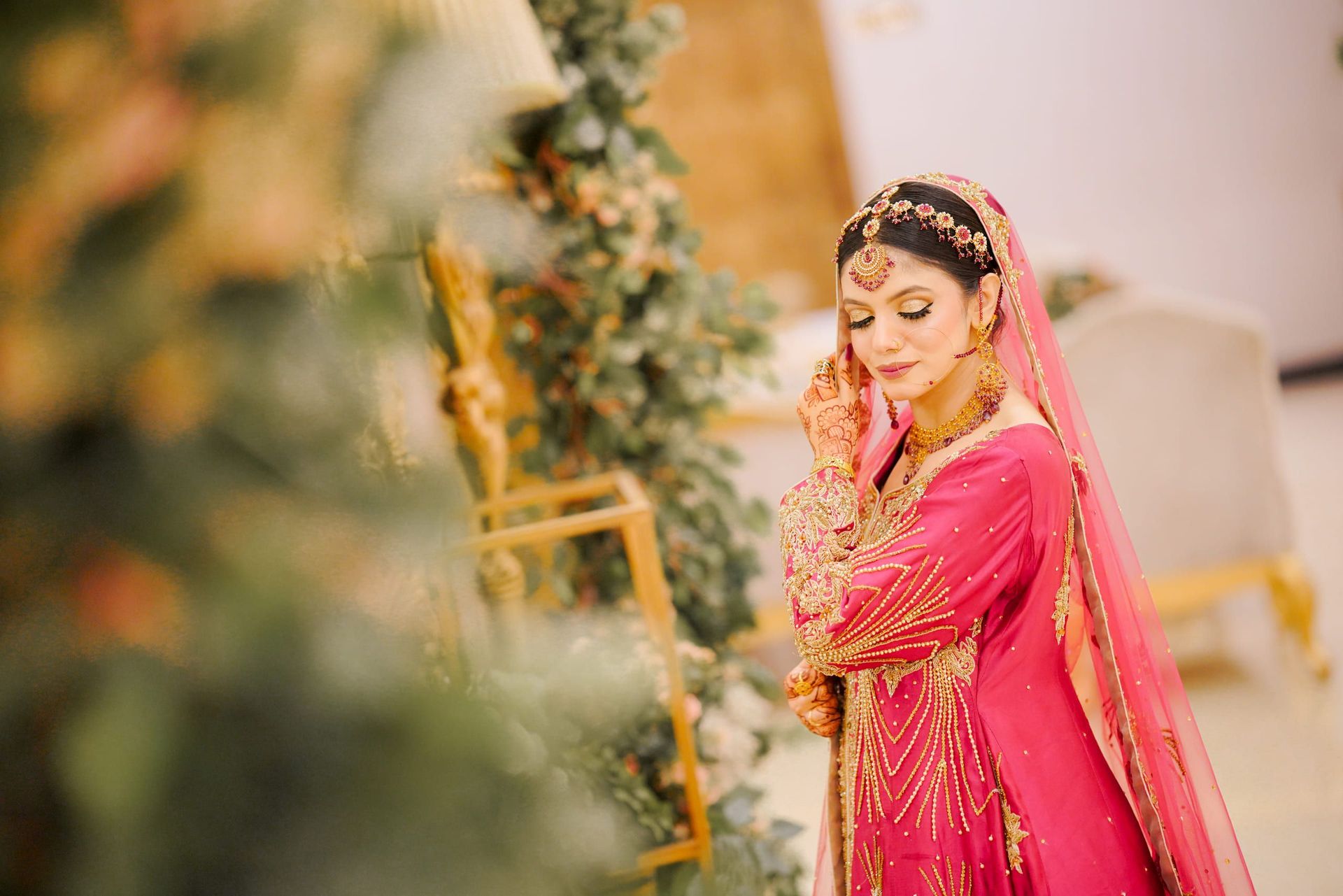 Bride in a pink formal outfit with traditional jewellery, Lahore bridal portrait