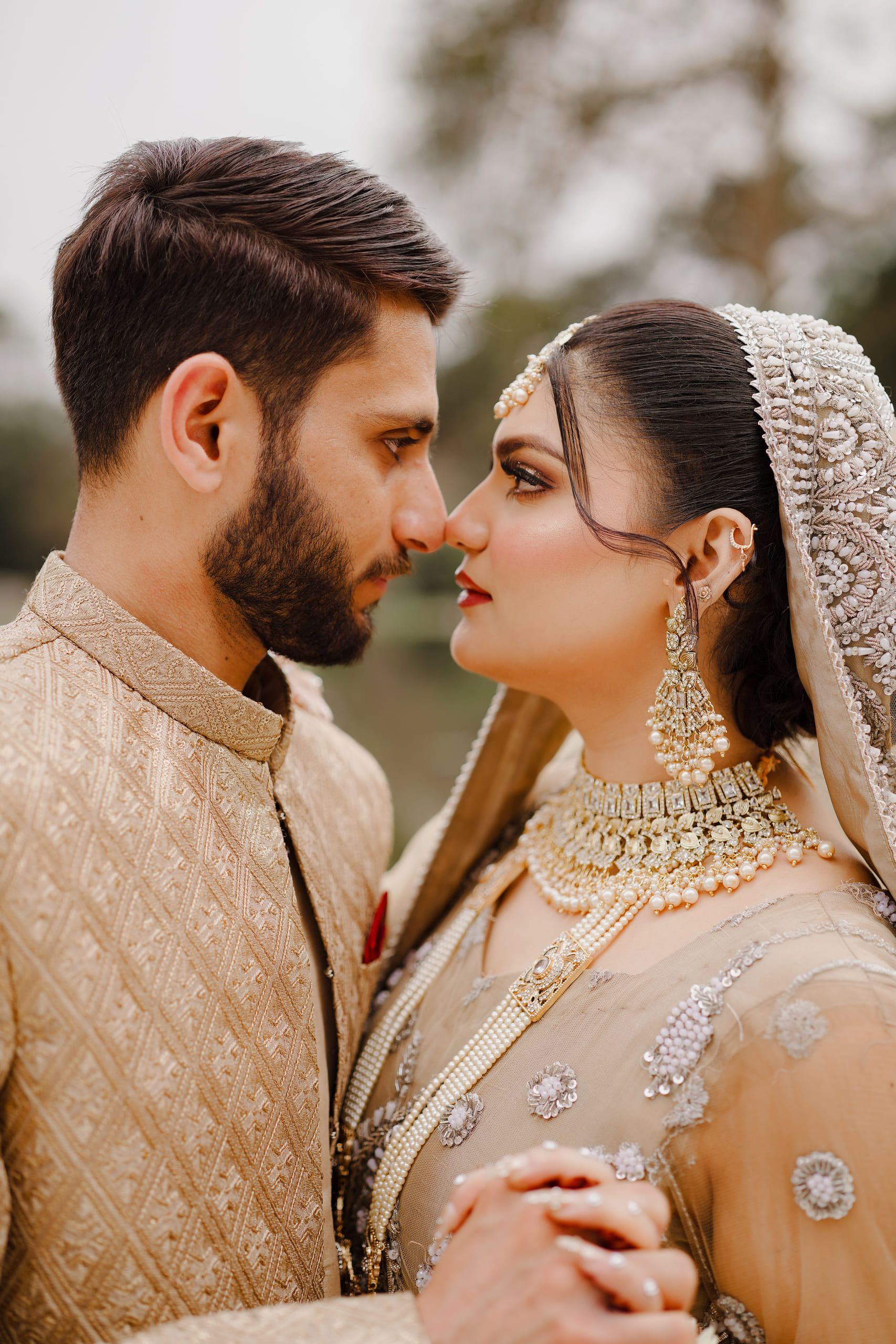 Close portrait of a bride and groom in gold formals, Lahore wedding photography